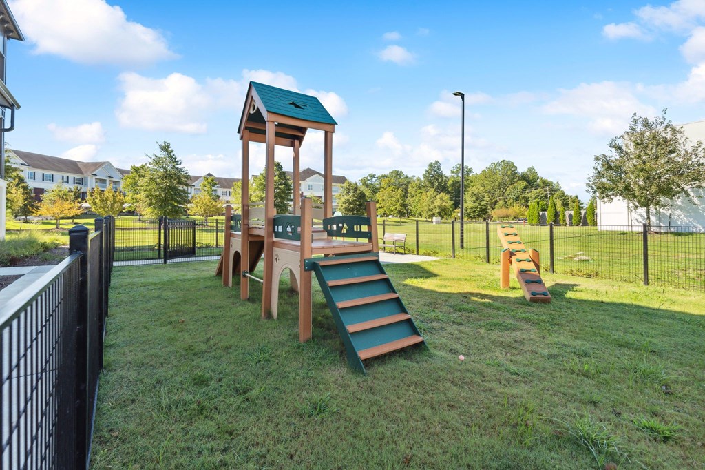 a playground at a park with a tall wooden tower
