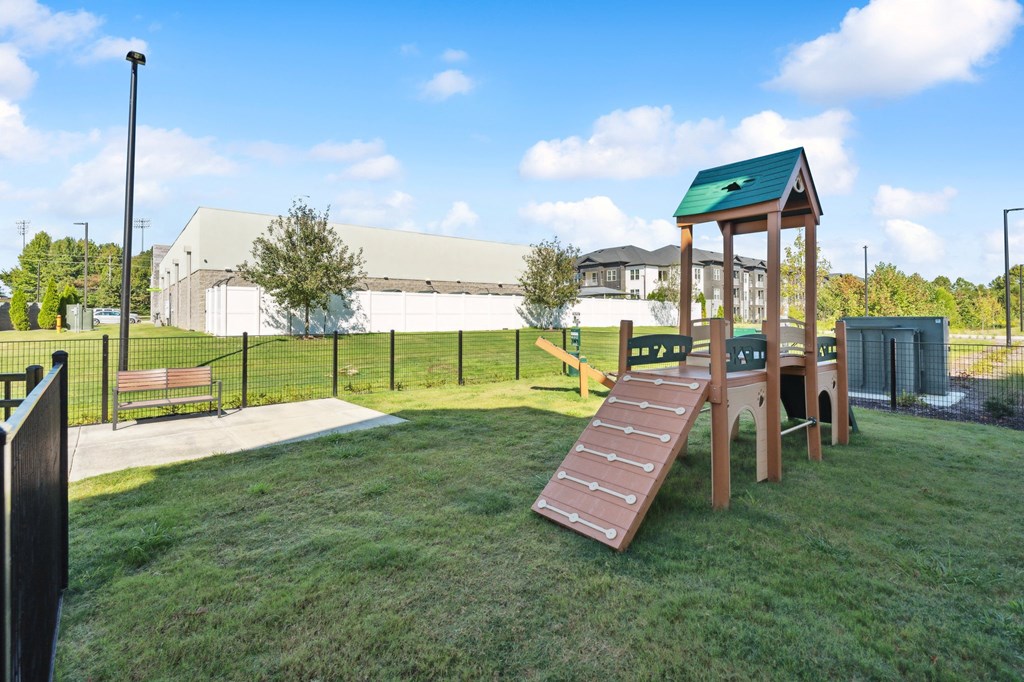 a playground in a park with a wooden playset