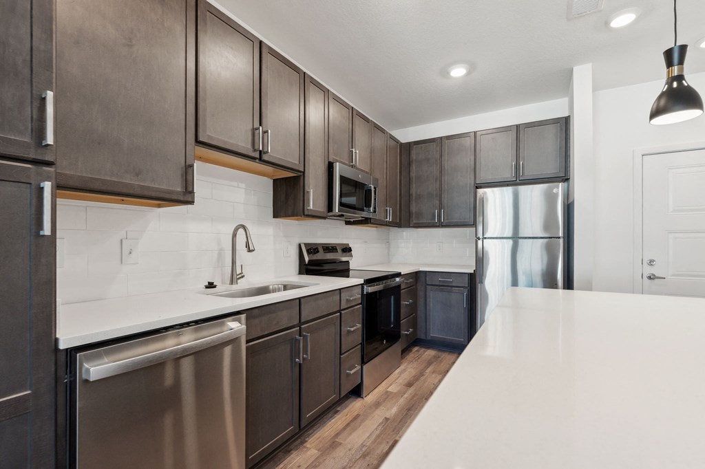 a kitchen with stainless steel appliances and wooden cabinets