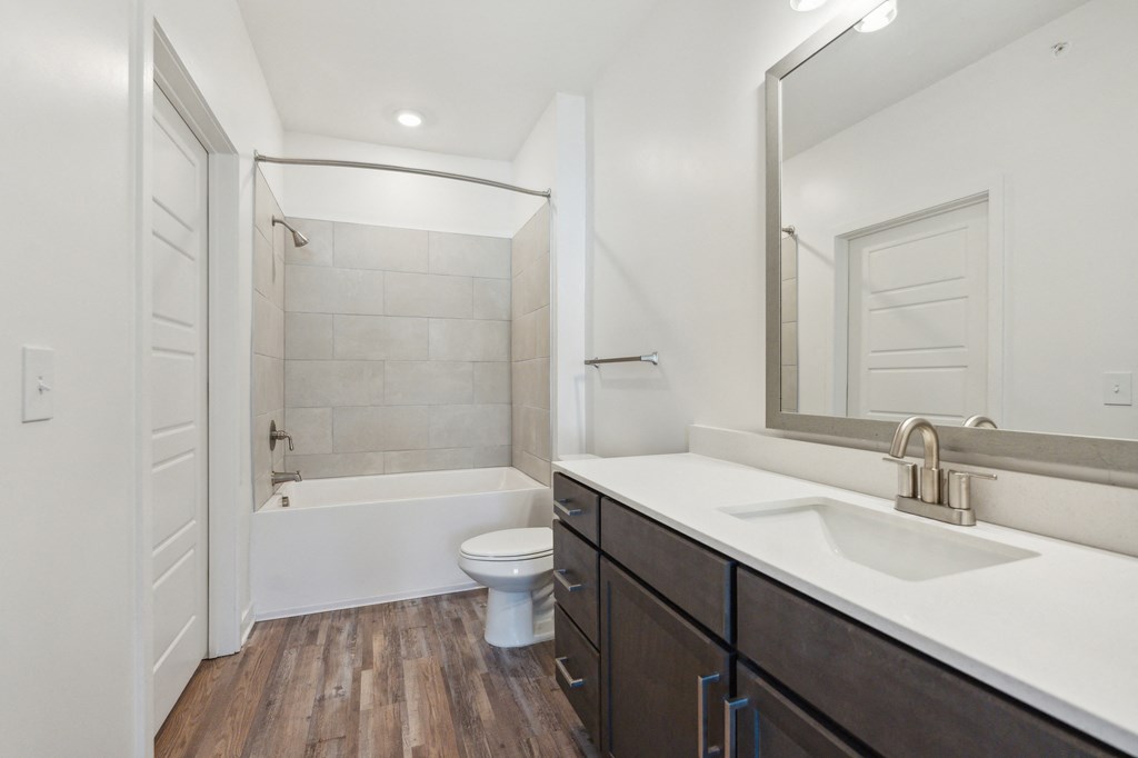a bathroom with a sink and a toilet and a shower