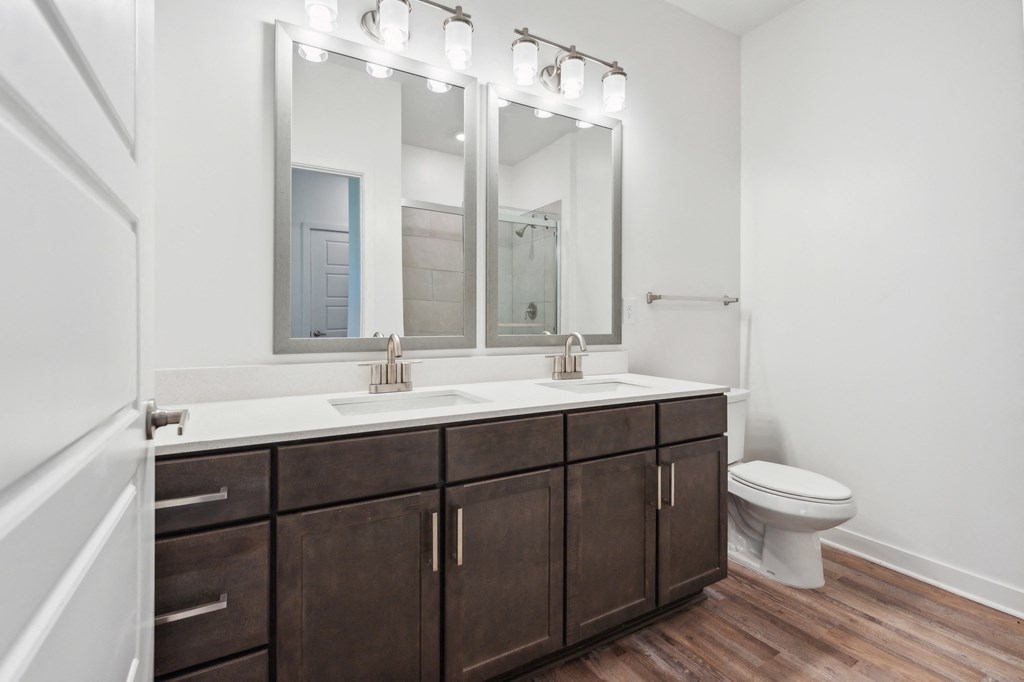 a bathroom with two sinks and a toilet