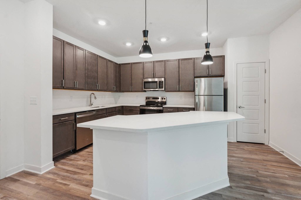 a kitchen with a large white counter top and
