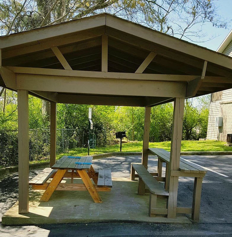 a picnic table sitting under a pavilion