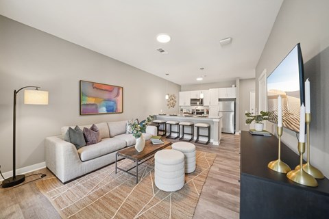 A modern living room with a white sofa and a coffee table.