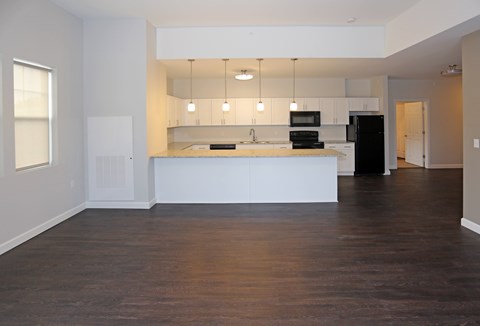 A kitchen with white cabinets and black appliance at Promenade at Founders Square Apartments in Indianapolis, IN