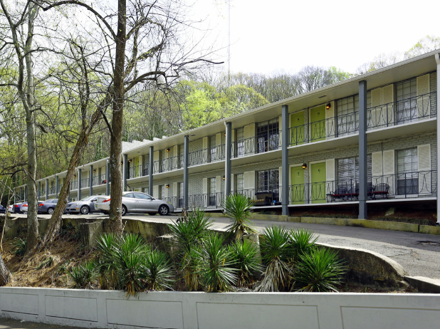 an apartment building with cars parked in front of it