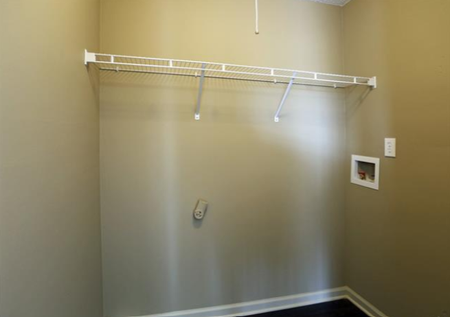 a empty closet with a white rack on the wall