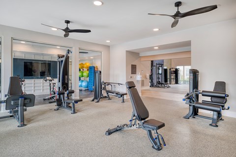 A spacious home gym with a variety of exercise equipment.