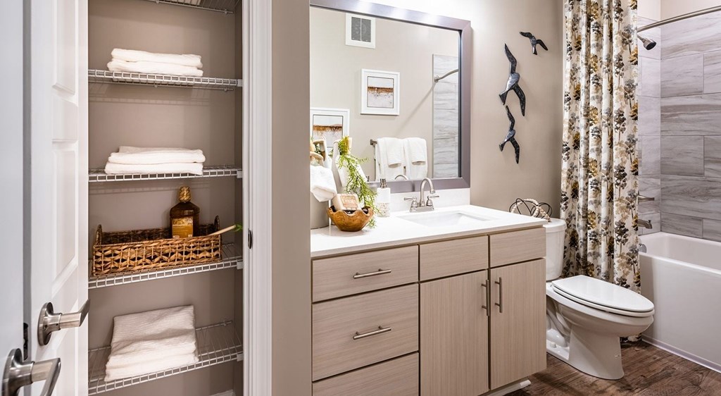 A bathroom with a towel rack and a mirror.