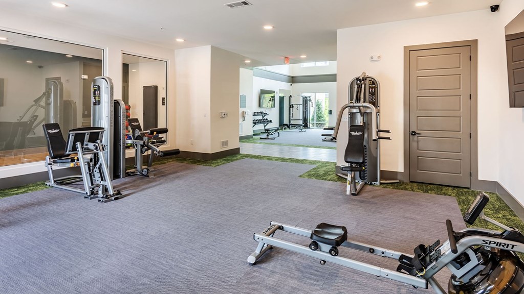 A spacious home gym with a variety of exercise equipment.