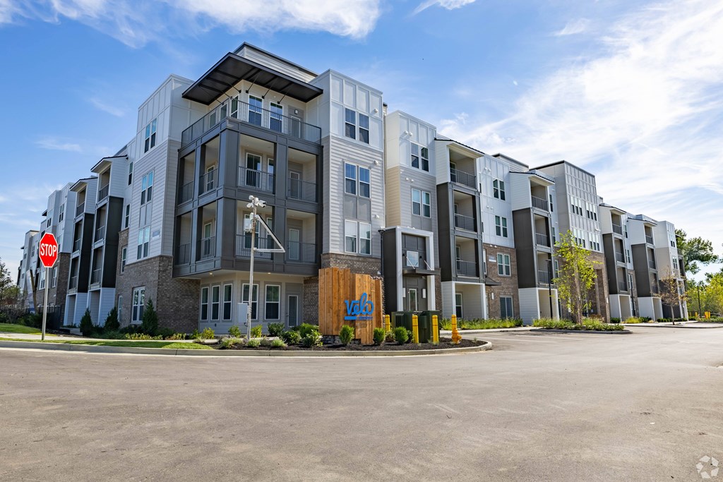 A large apartment complex with a stop sign in front.