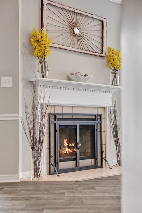Living room with a fireplace and wood-style flooring at Village at Caldwell in Birmingham, AL
