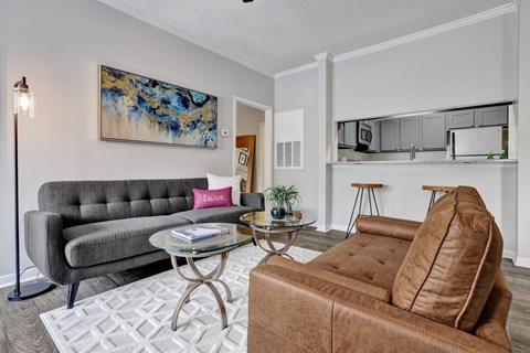 A living room with wood-style flooring at Village at Caldwell Apartments in Birmingham, AL