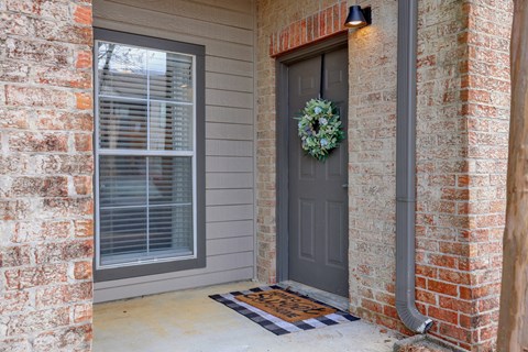 A grey door with a wreath on it at Village at Caldwell Mill in Birmingham, AL