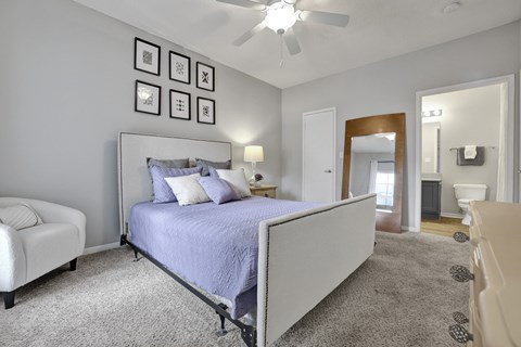 Primary bedroom with ensuite bathroom at Village at Caldwell Apartments in Birmingham, AL