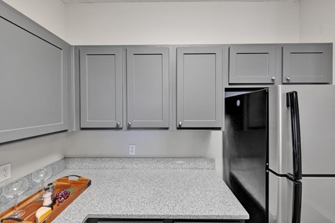 A remodeled kitchen with stainless steel appliances at Village at Caldwell Apartments in Birmingham, AL