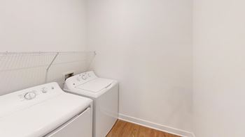 full size washer/dryer in a laundry room at Wesley Place Apartments in Indianapolis, Indiana