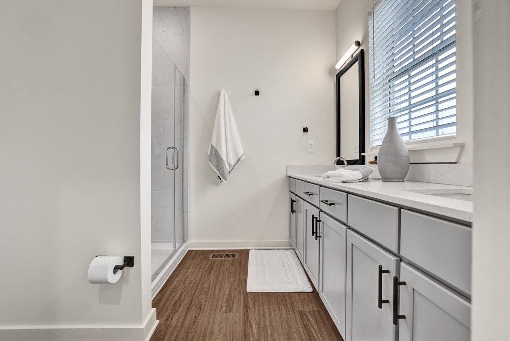 Bathroom with double vanity and quartz countertops at West Row Lofts and Townhomes in Birmingham, AL