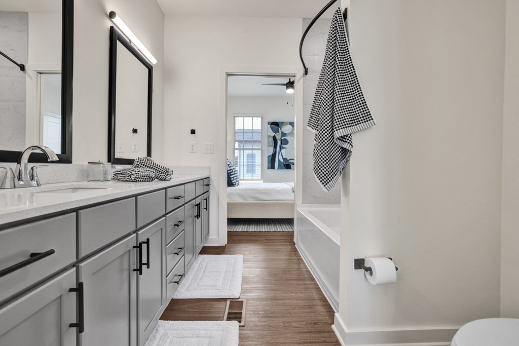 A bathroom with a checkered towel hanging on the wall.