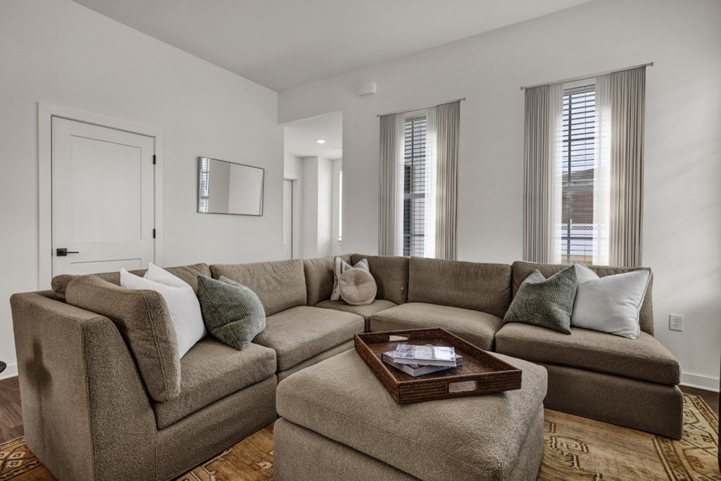 A living room with wood-style flooring at West Row Townhomes and at West Row Townhomes at West Row Lofts and Townhomes in Birmingham, AL