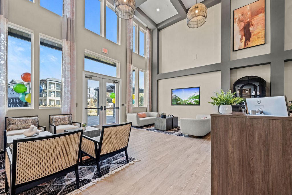 a lobby with tables and chairs and a fire place