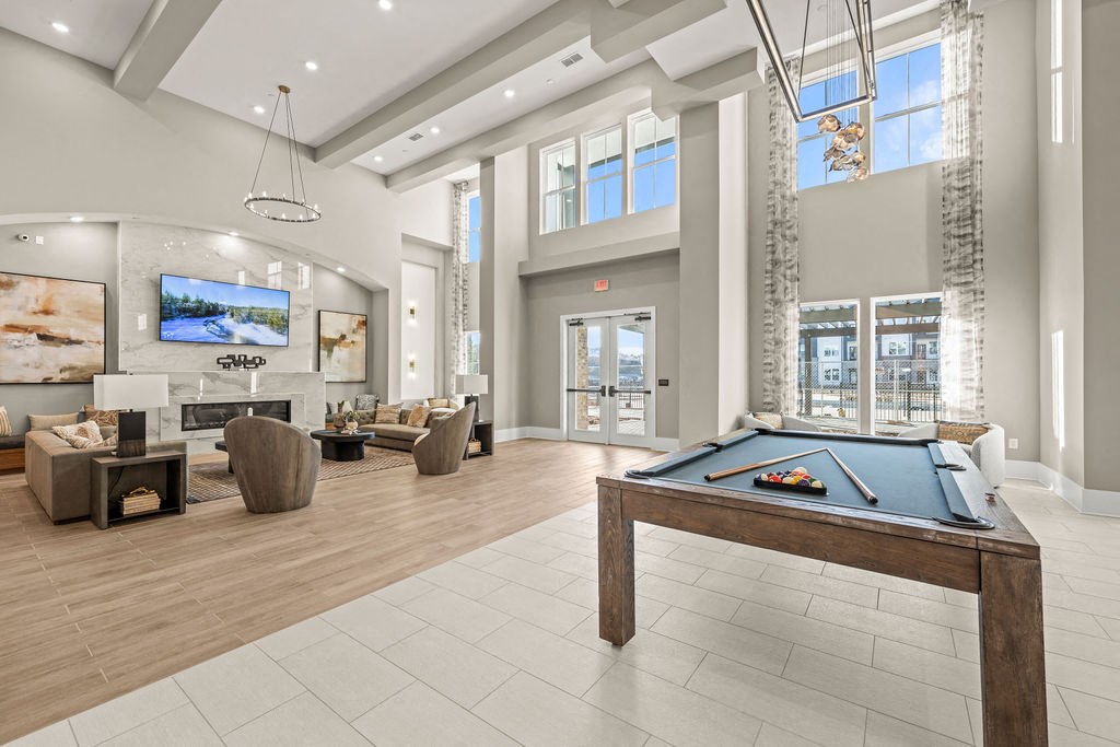 a game room with a pool table and a fireplace
