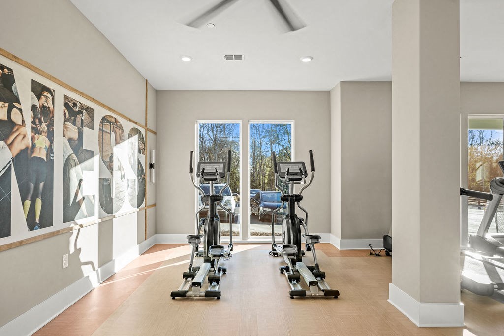 the gym in the owners home has treadmills and pictures on the wall