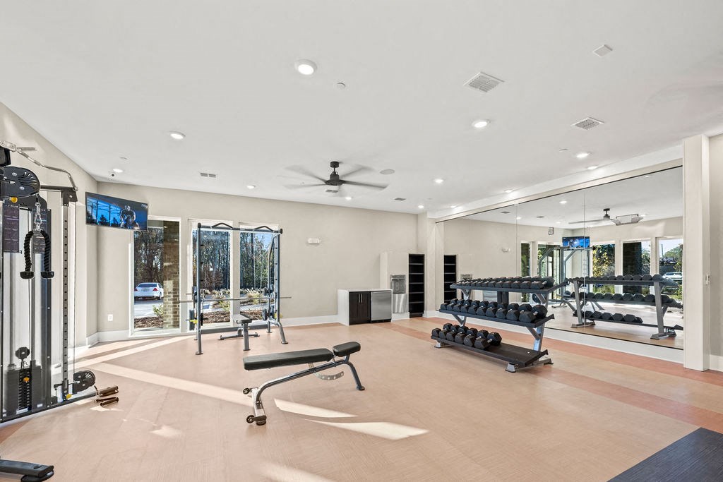 the gym has a retractable glass wall and plenty of exercise equipment