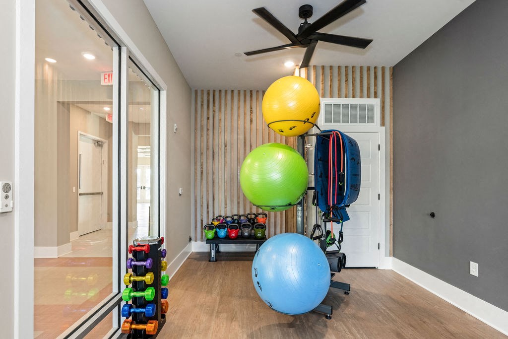 the living room has a ceiling fan and toys on the floor