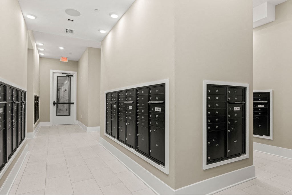 a long hallway with a bunch of mailboxes on the wall