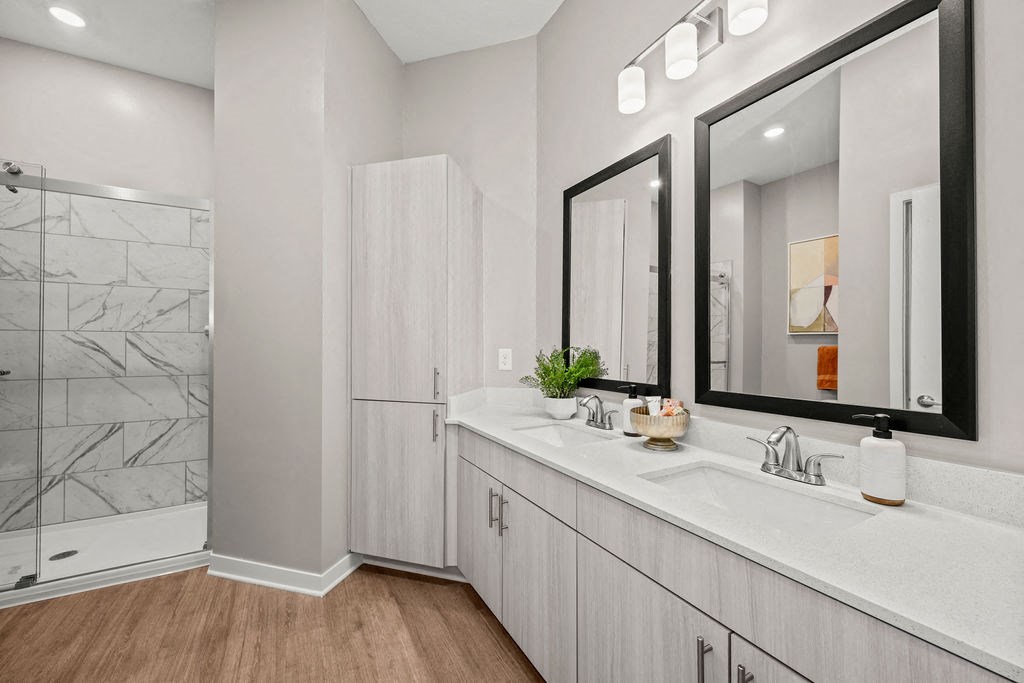 a bathroom with two sinks and a shower