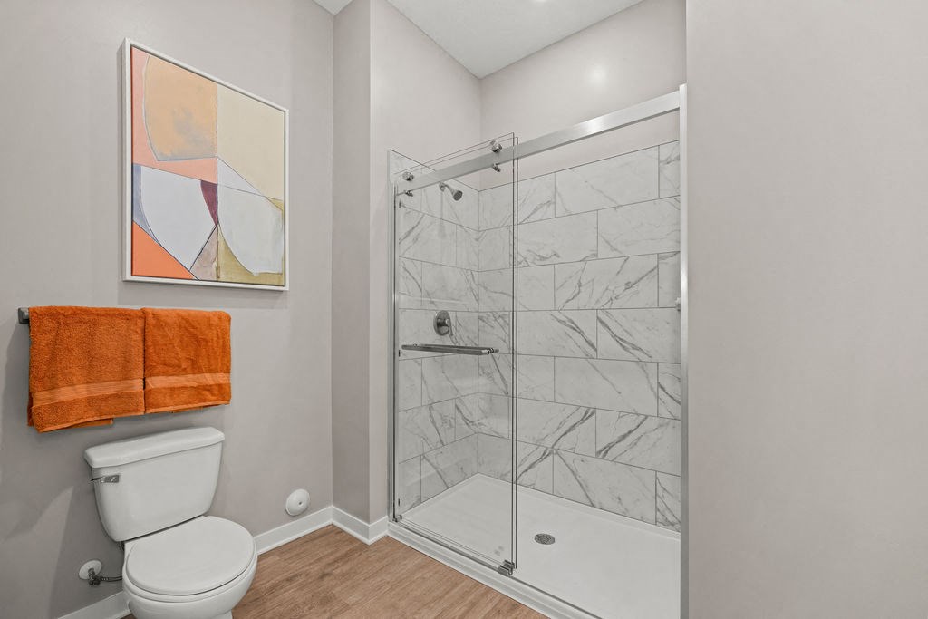 a bathroom with a shower and a toilet in it