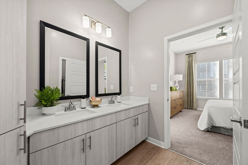 a bathroom with two mirrors and a sink