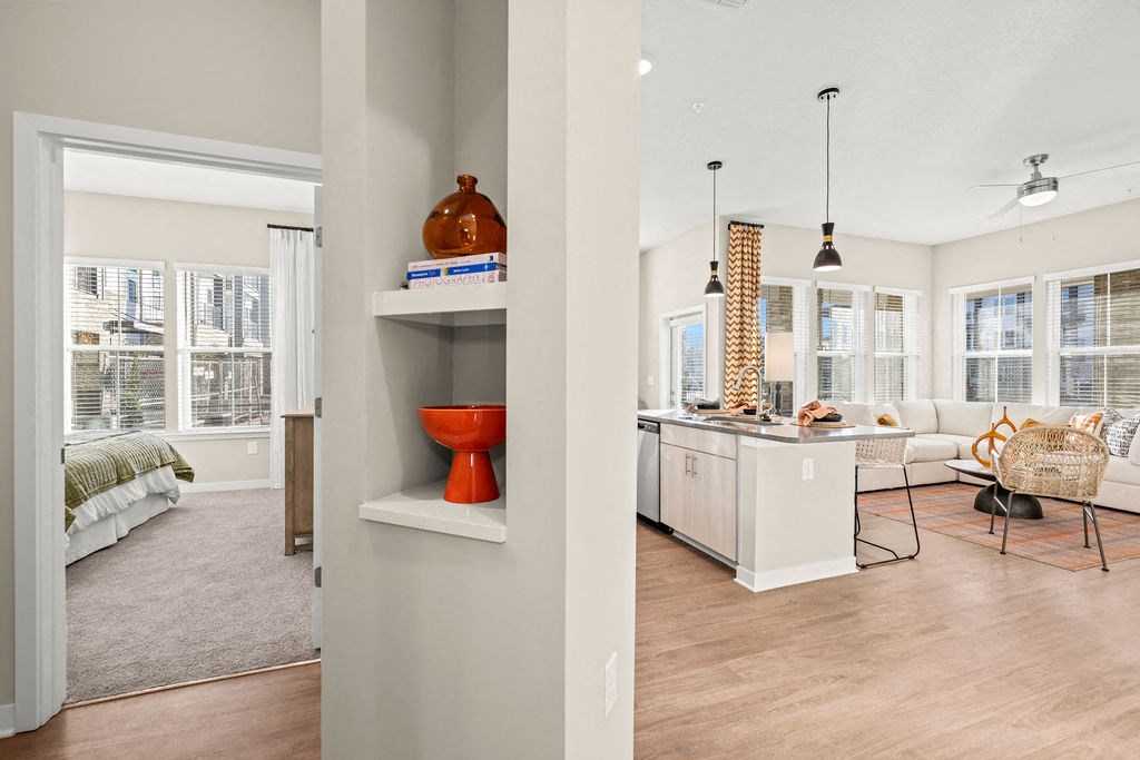 a living room and kitchen with a couch and a table