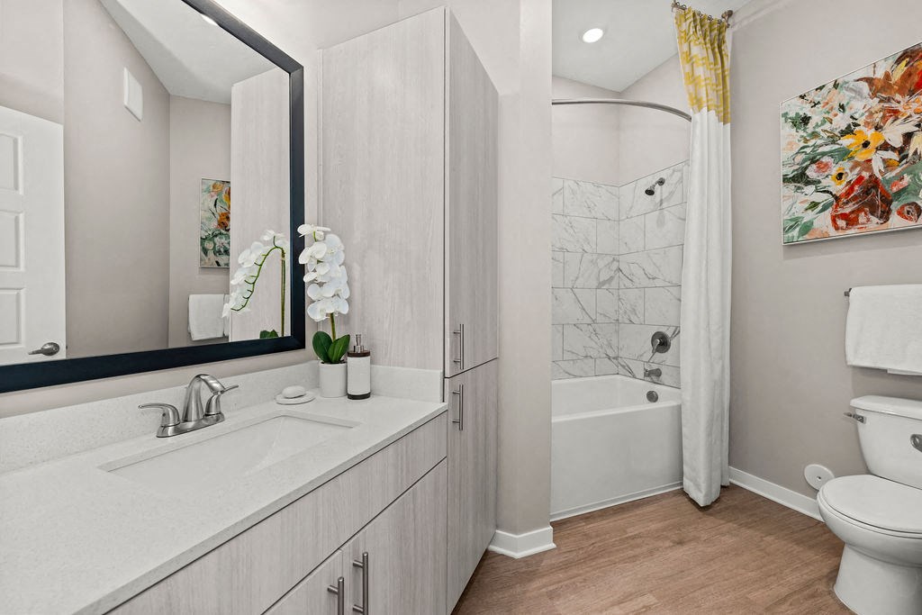 a bathroom with a mirror and a toilet and a shower