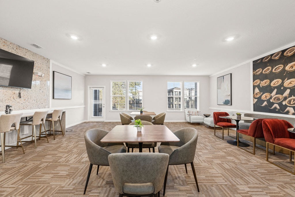 a living room with a table and chairs