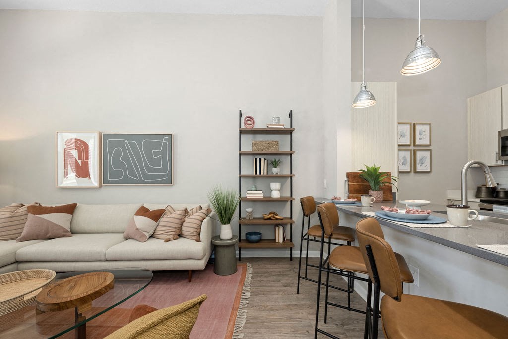 a living room with a couch and a kitchen