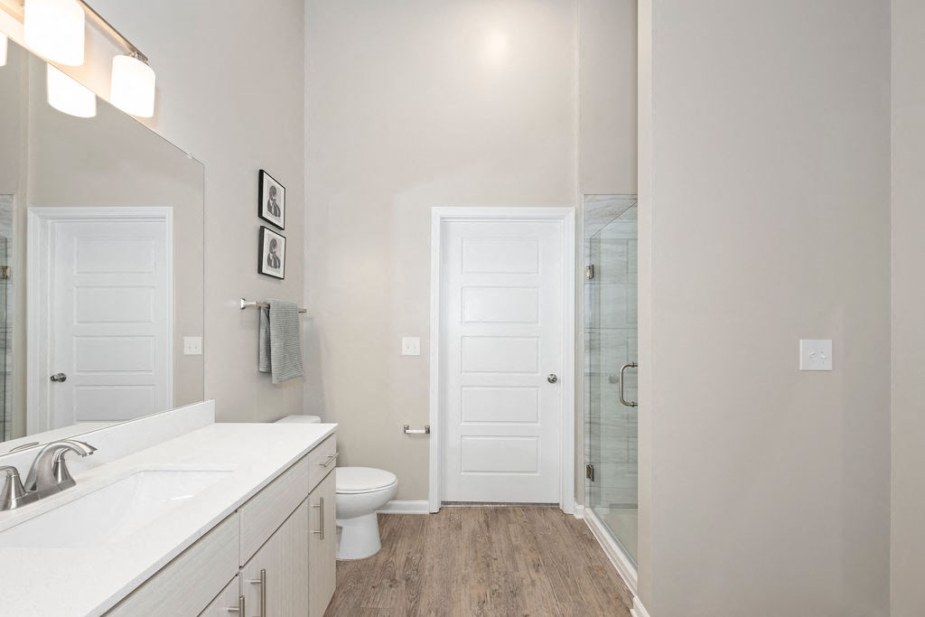 a bathroom with a shower and a sink and a mirror