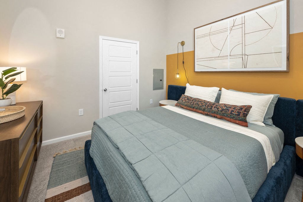 a bedroom with a bed and a white door