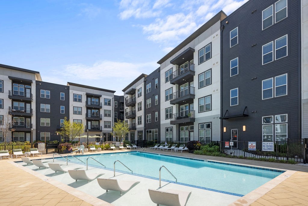 a swimming pool in front of an apartment building