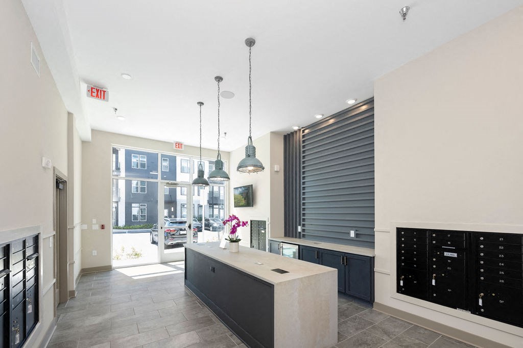 a kitchen with a large island and a door to a street