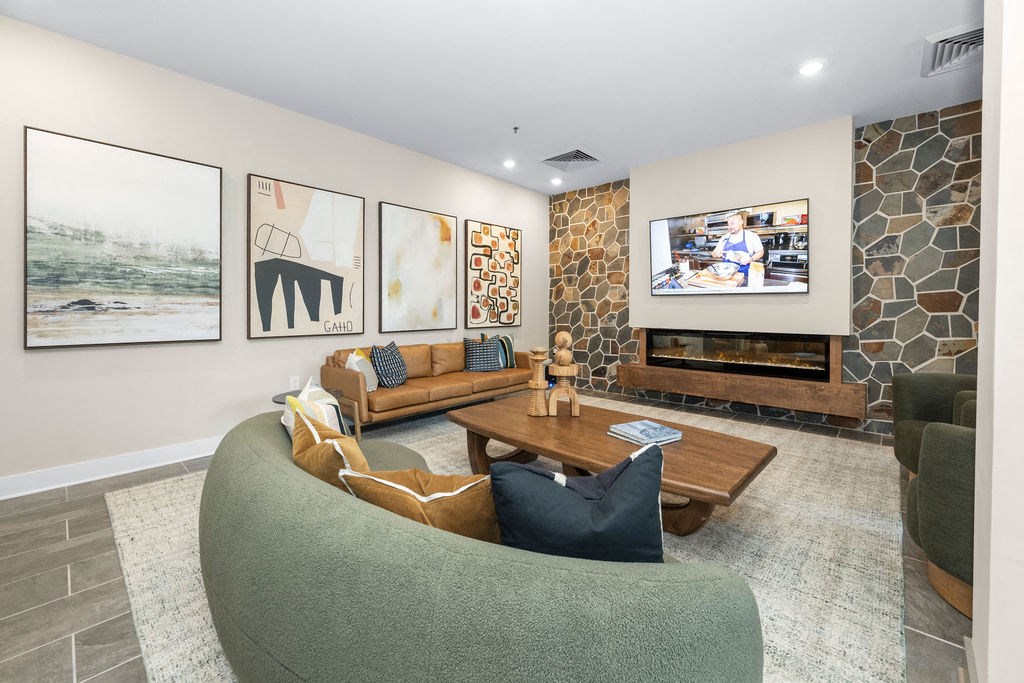 a living room with couches and a coffee table and a television