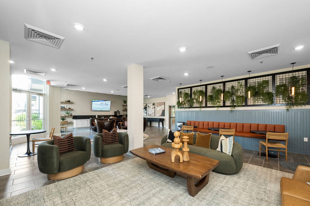 a lobby with couches and chairs and a table