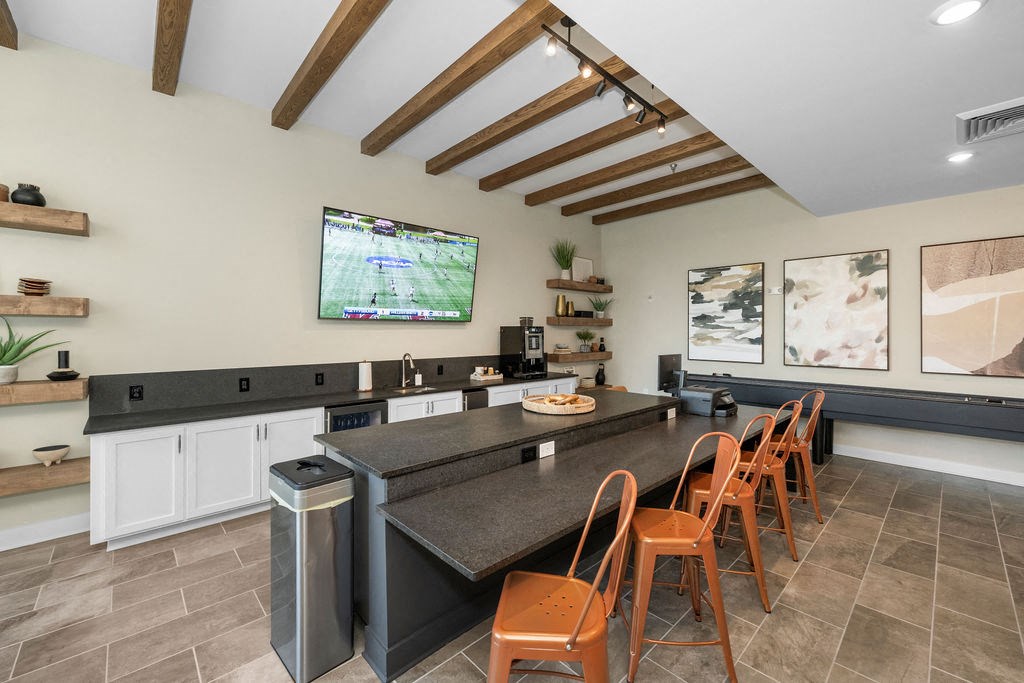 a kitchen with a large counter top and a tv