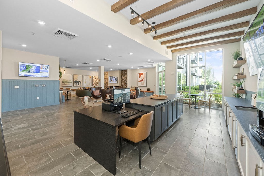 a lobby with a counter and a desk with chairs
