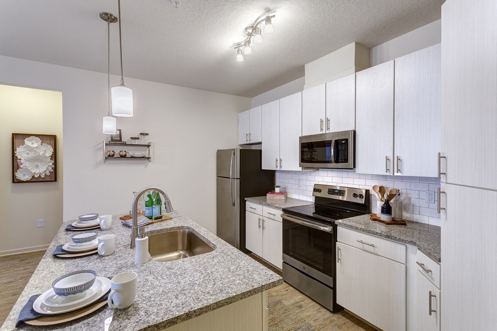 a kitchen with granite counter tops and stainless steel appliances