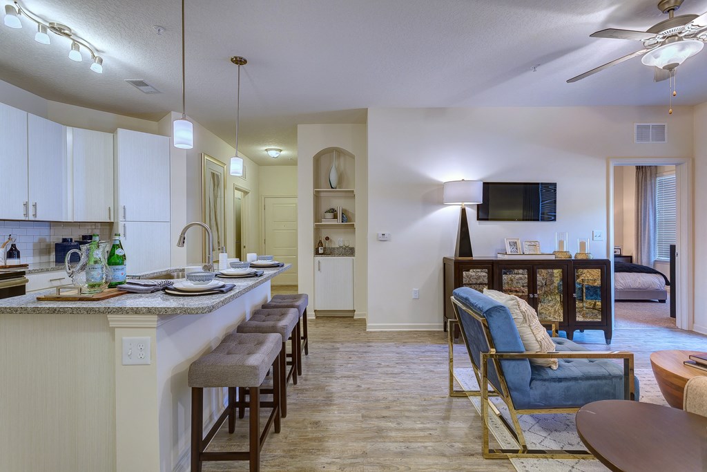 a kitchen and living room with a dining area and a living room