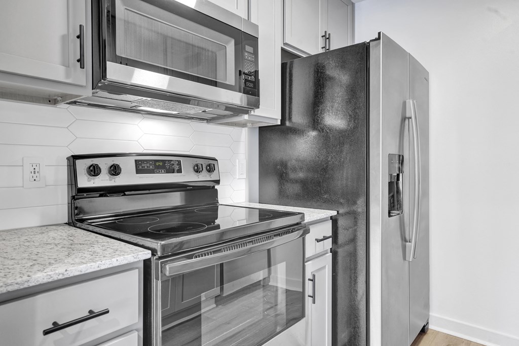 a kitchen with stainless steel appliances and a refrigerator