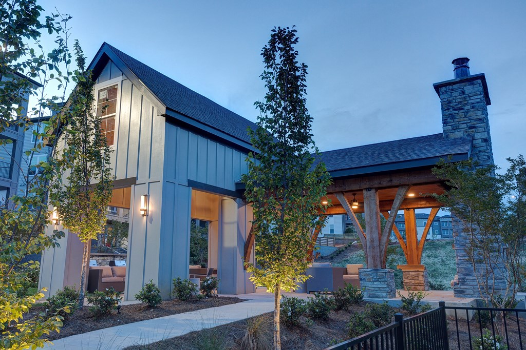 a view of the front of a house with trees and a patio