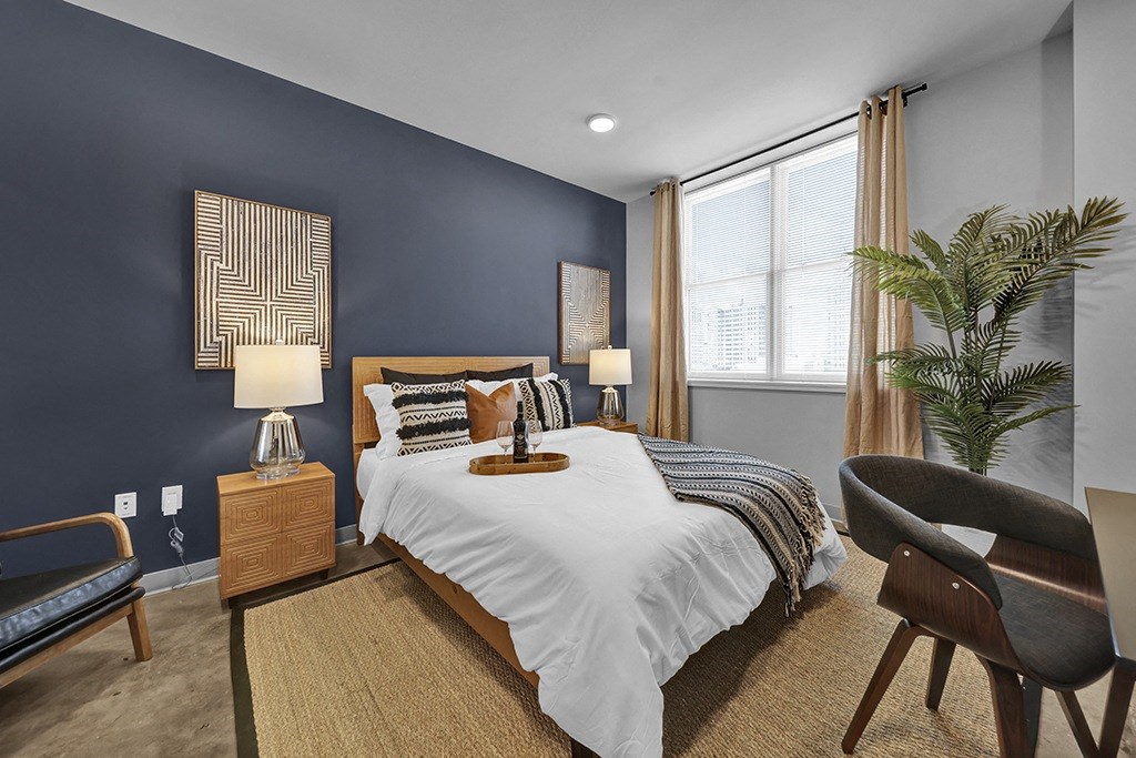 a bedroom with blue walls and a white bed